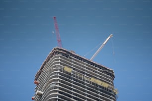 a tall building with a crane on top of it