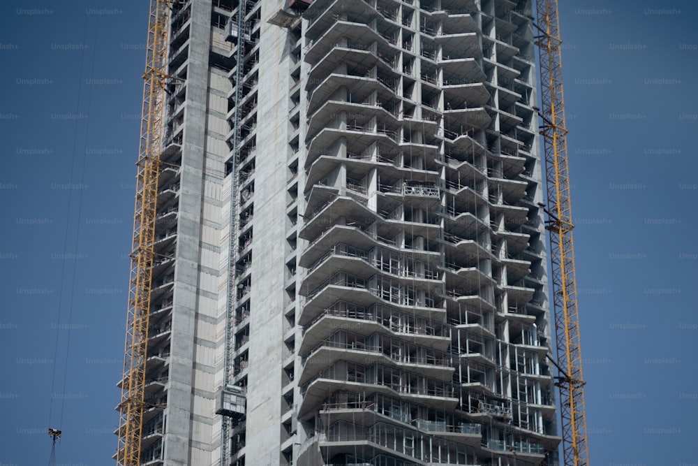 a tall building with a crane on top of it