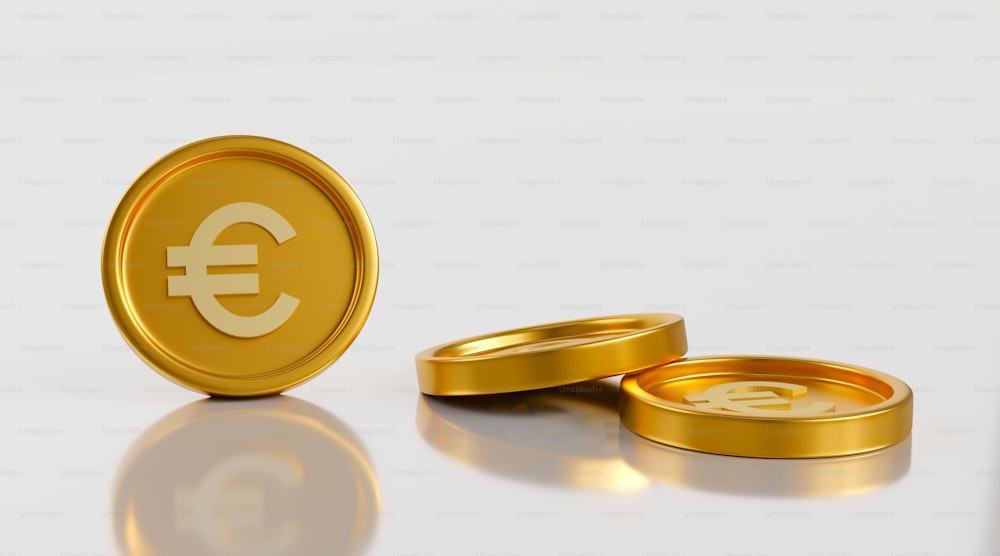 two gold rings with a currency symbol on them