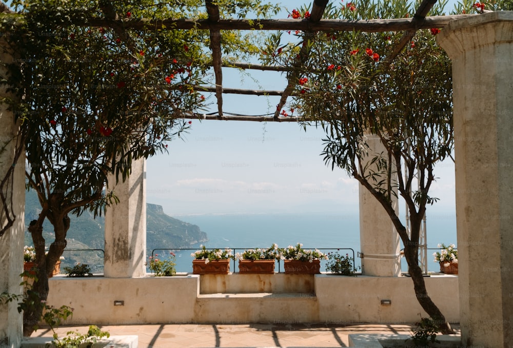 a view of the ocean through a stone archway