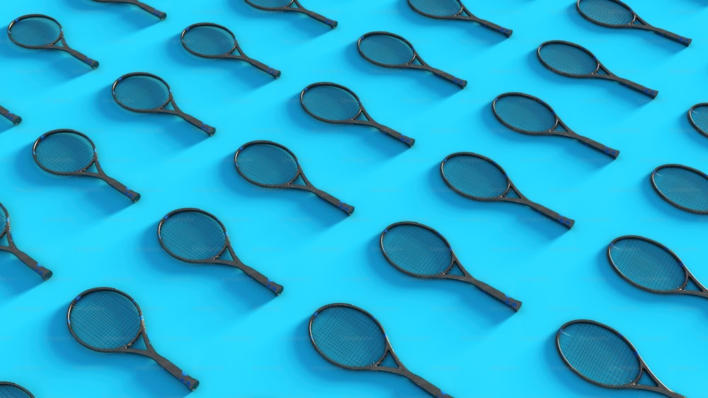 a group of tennis rackets sitting on top of a blue surface