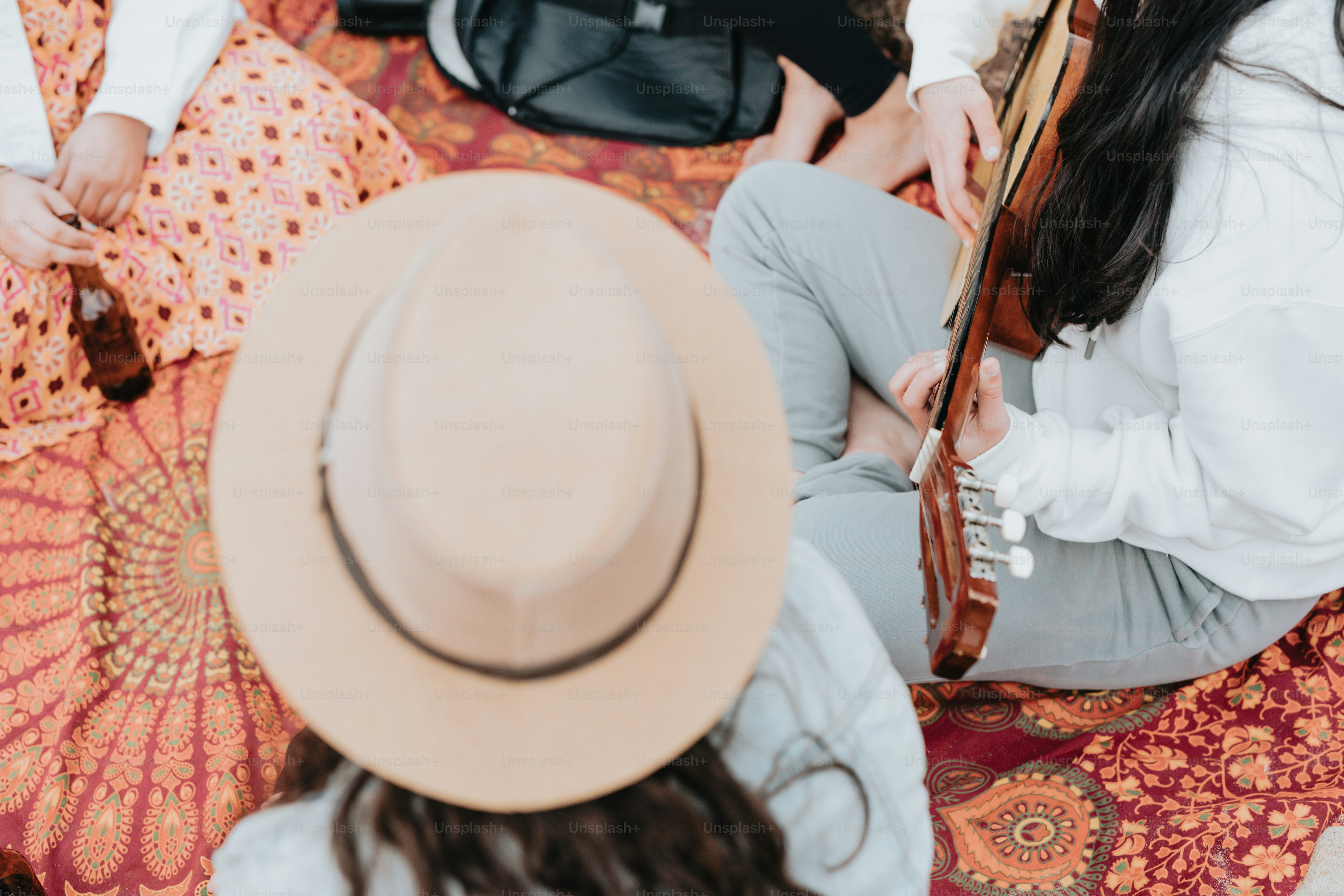 a group of people sitting on top of a floor next to each other