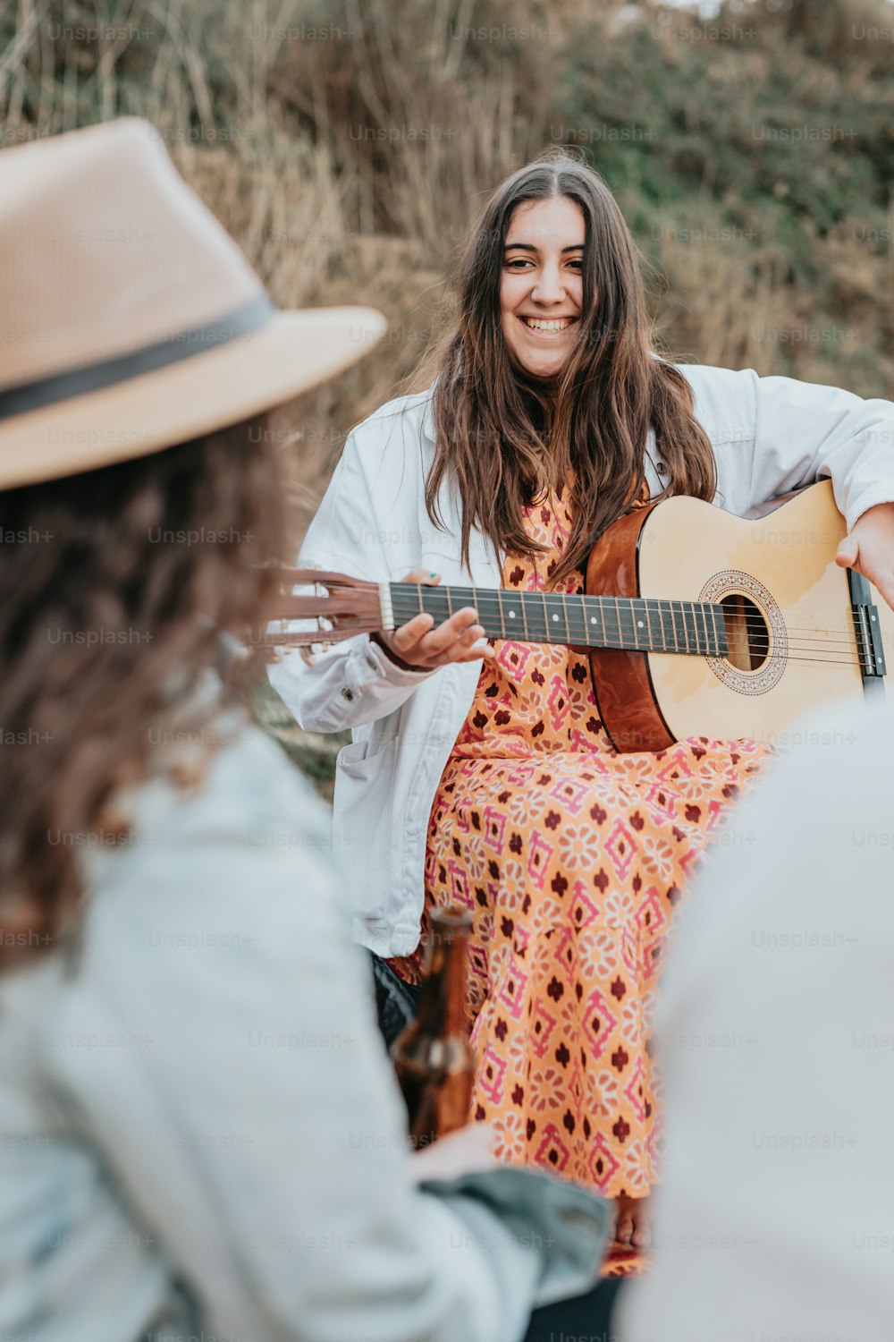 a woman in a dress playing a guitar