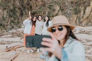 a group of women taking a picture with a cell phone