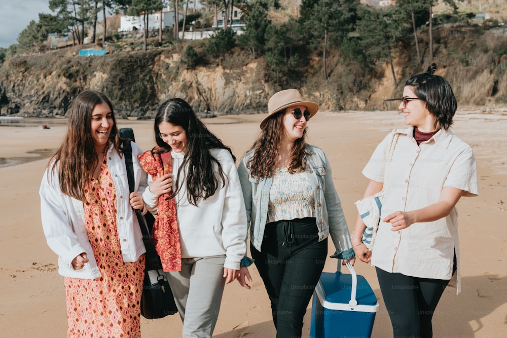 a group of young women walking along a beach