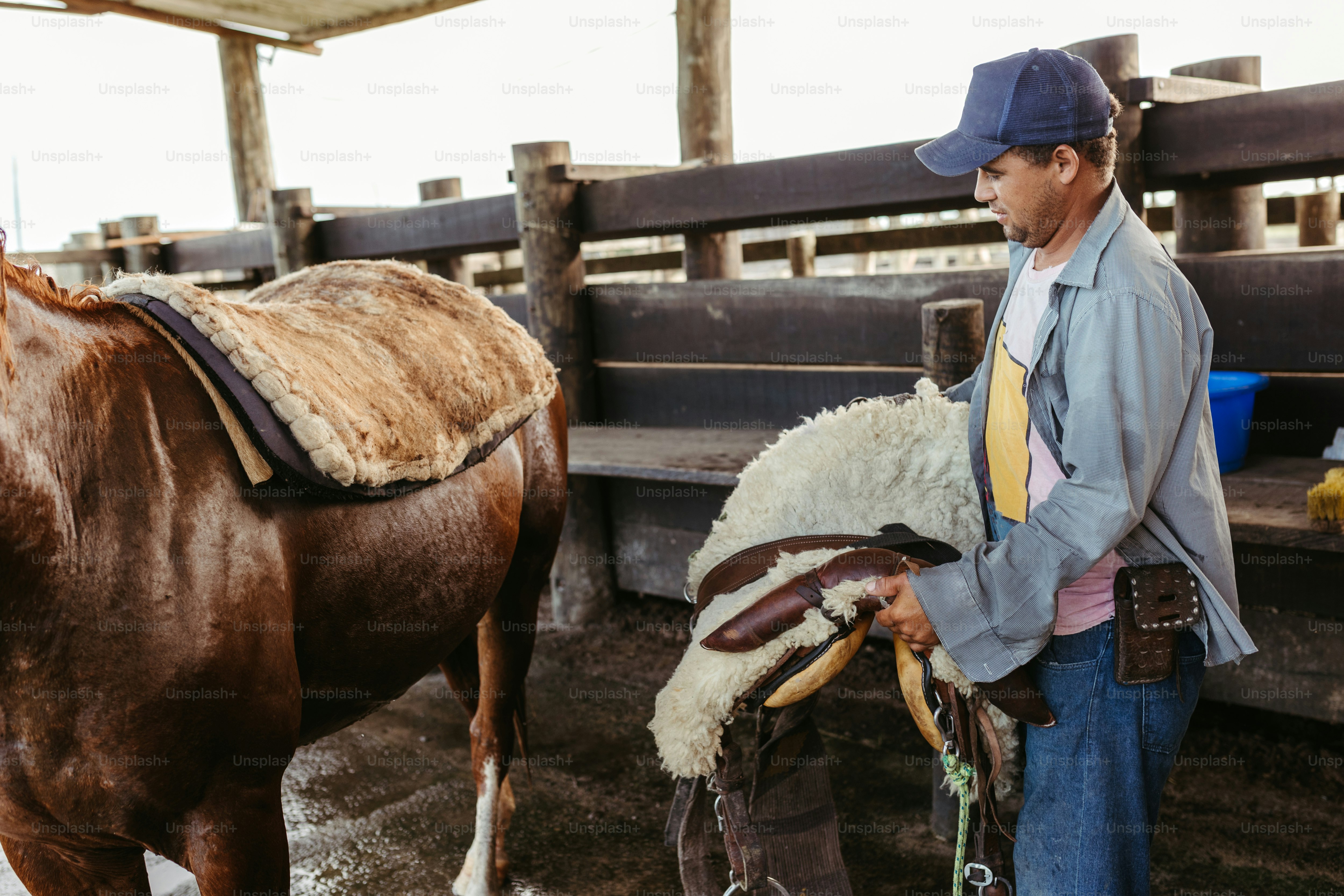 A man standing next to a brown horse photo – Cowboy Image on Unsplash