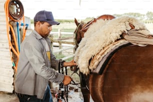 a man standing next to a brown horse