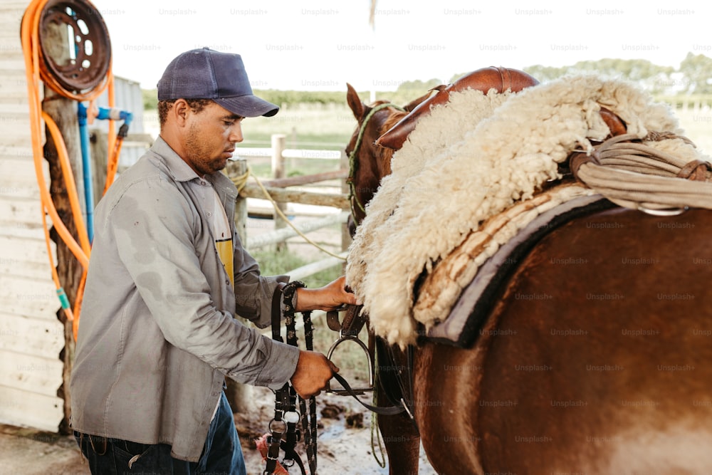 a man standing next to a brown horse