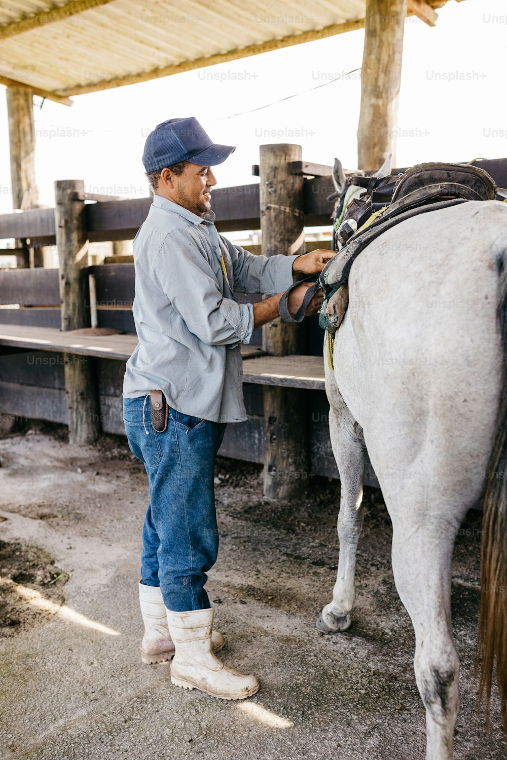 a man standing next to a white horse