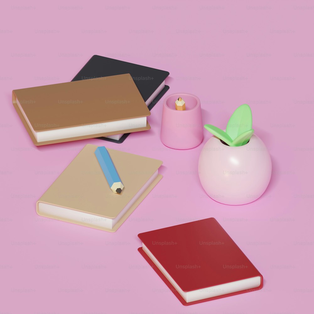 a pink table topped with notebooks and a pen