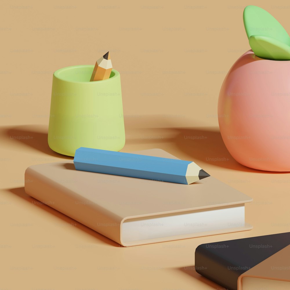 a book, pencil holder, and apple on a table