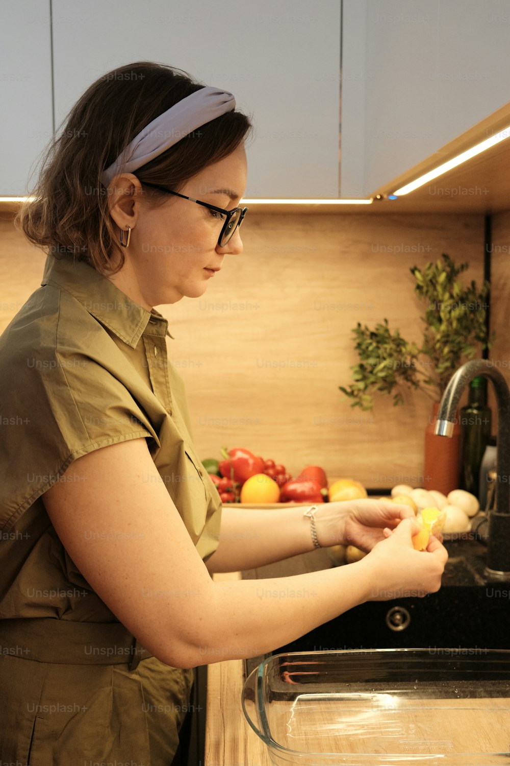 a woman in a kitchen preparing food on a counter