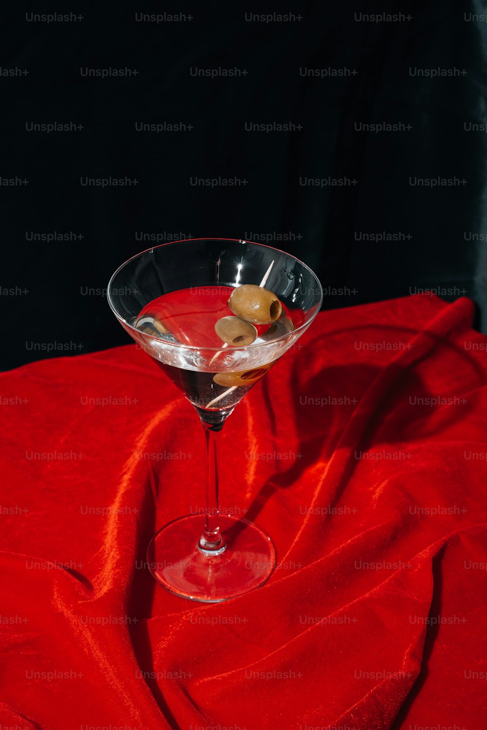 a red cloth with a martini glass on it