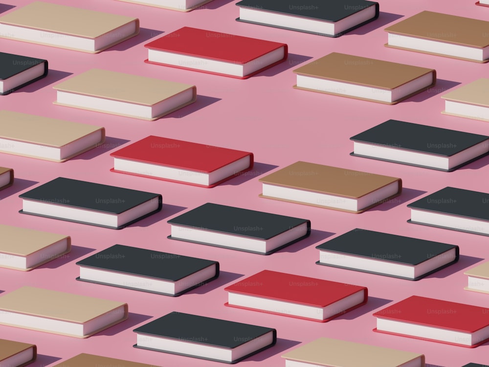 a group of books sitting on top of a pink surface