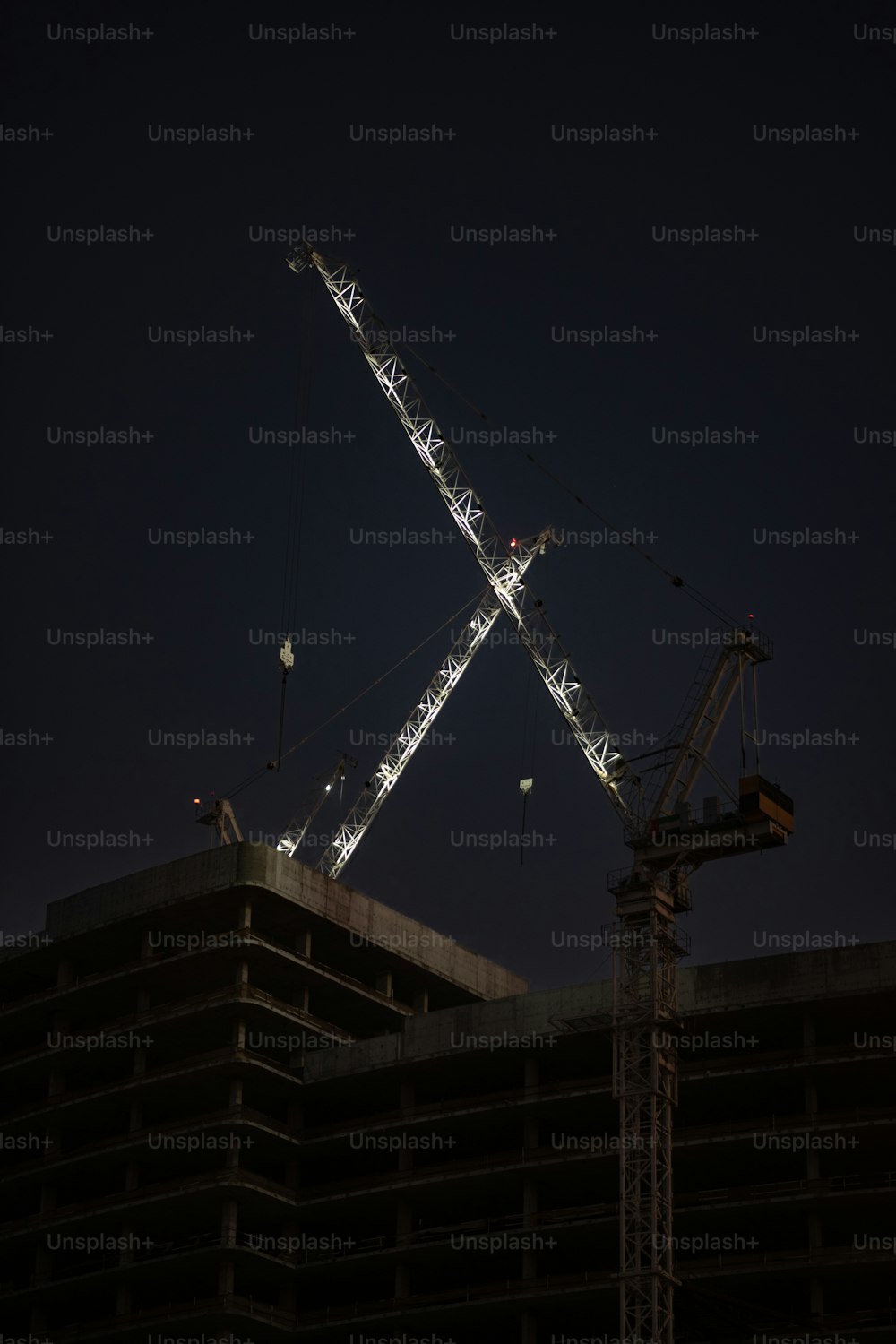 a crane is lit up in the night sky