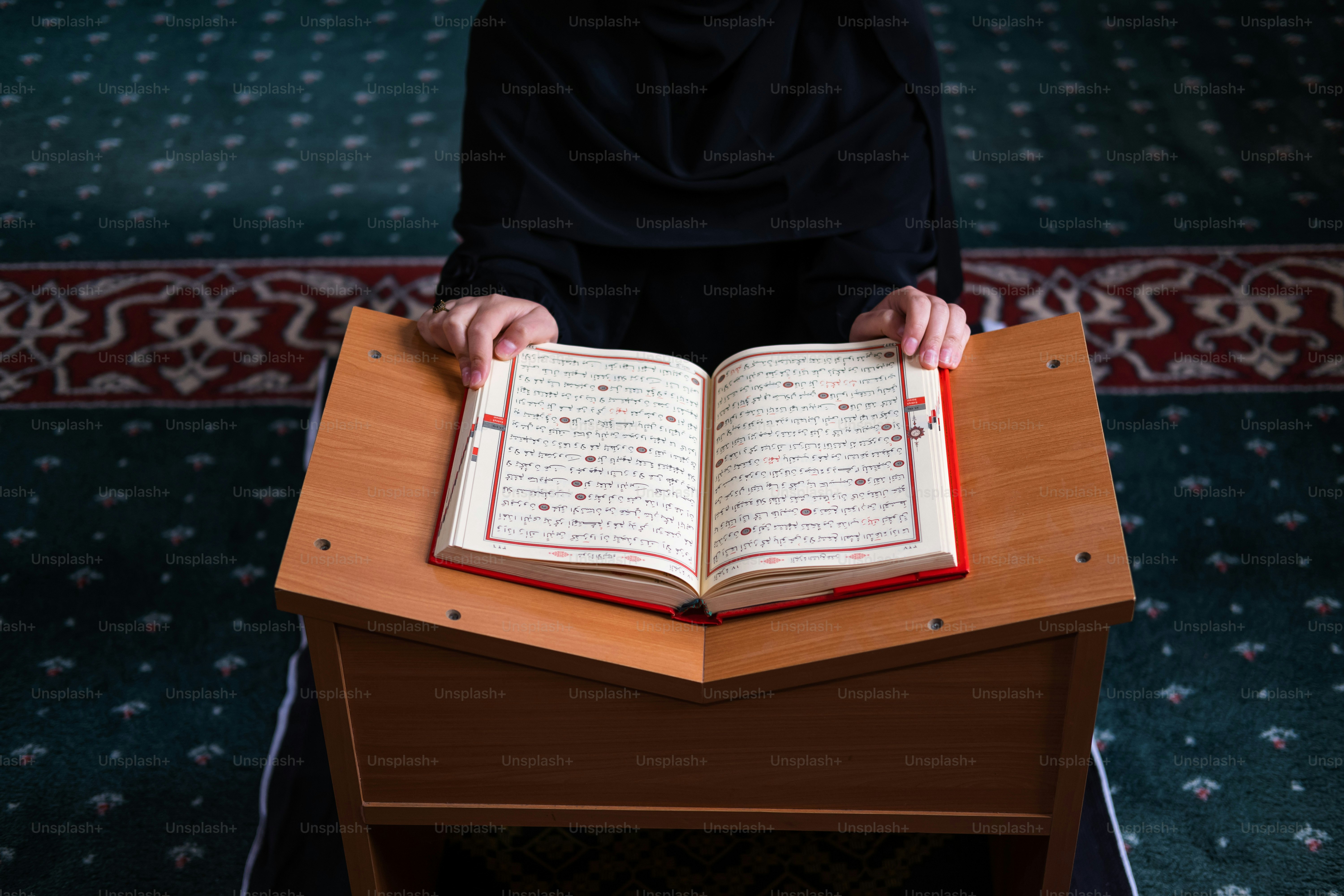 a person sitting at a table with an open book