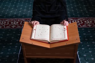 a person sitting at a table with an open book