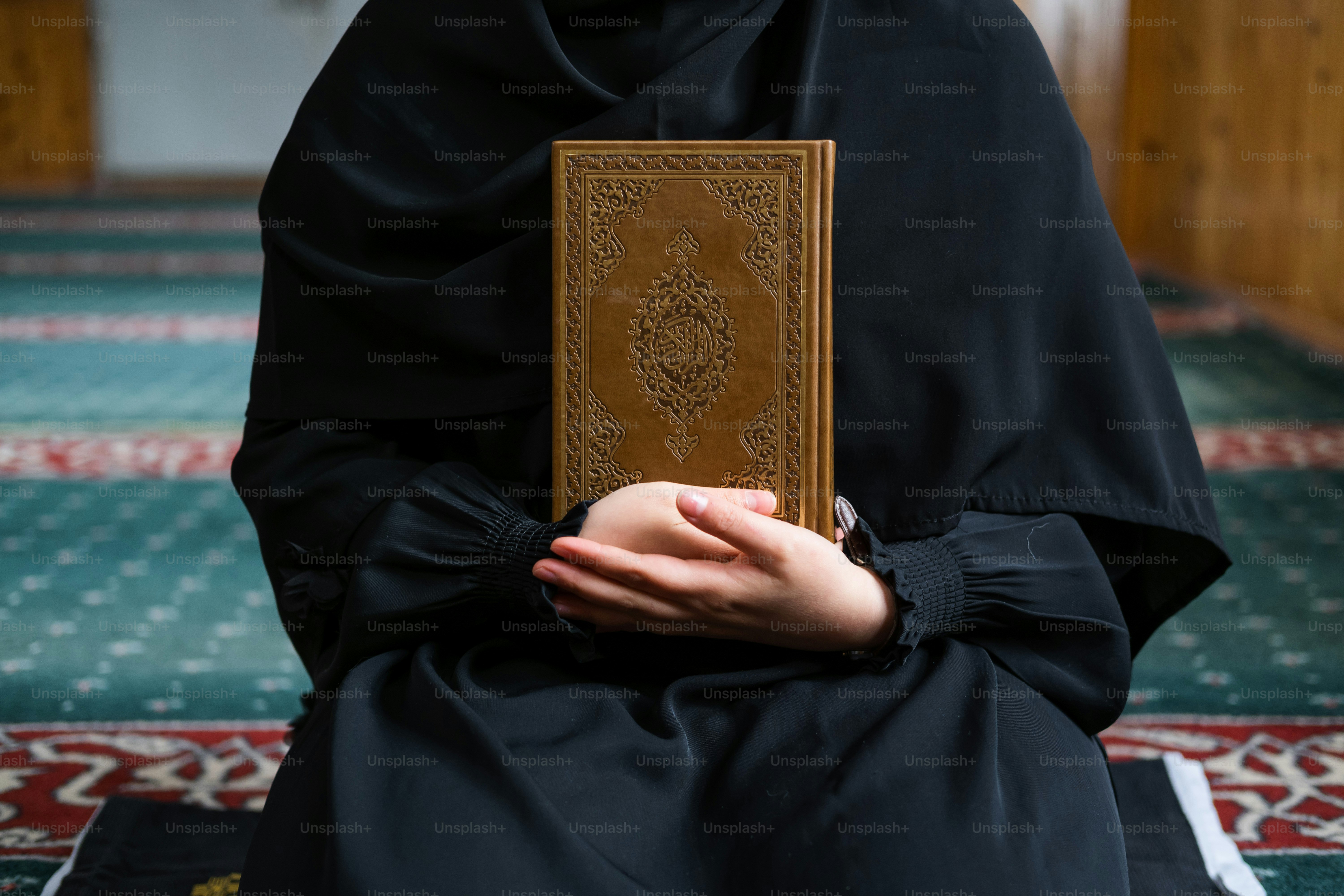 a person sitting down holding a book in their hands