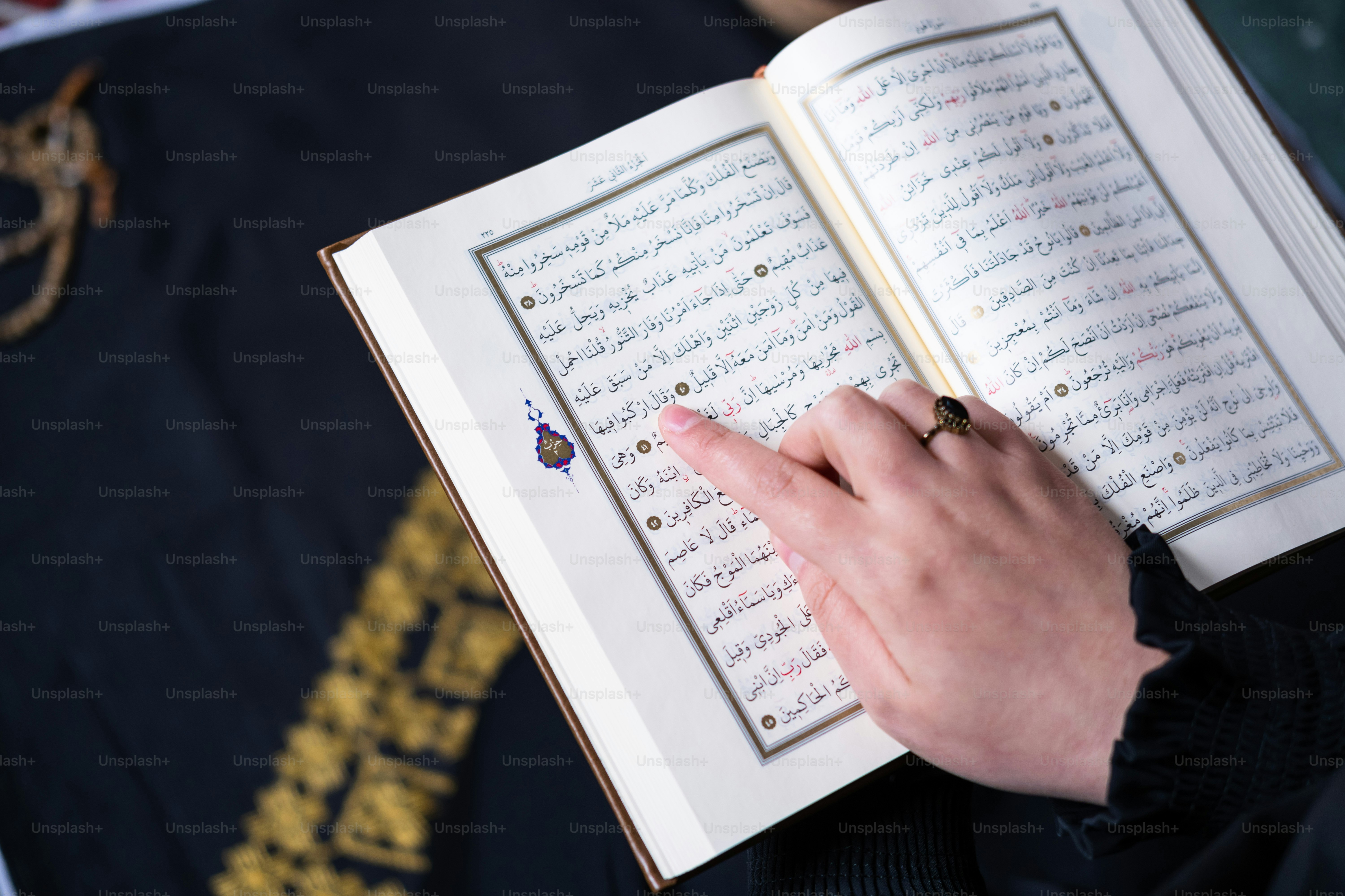 A person holding an open book in their hands photo – Islam Image on ...