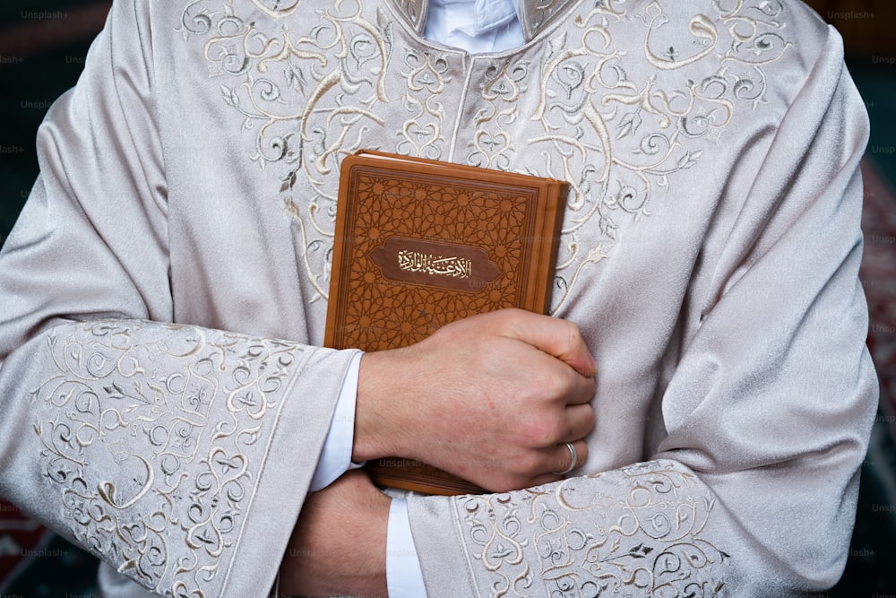 a man holding a book in his hands