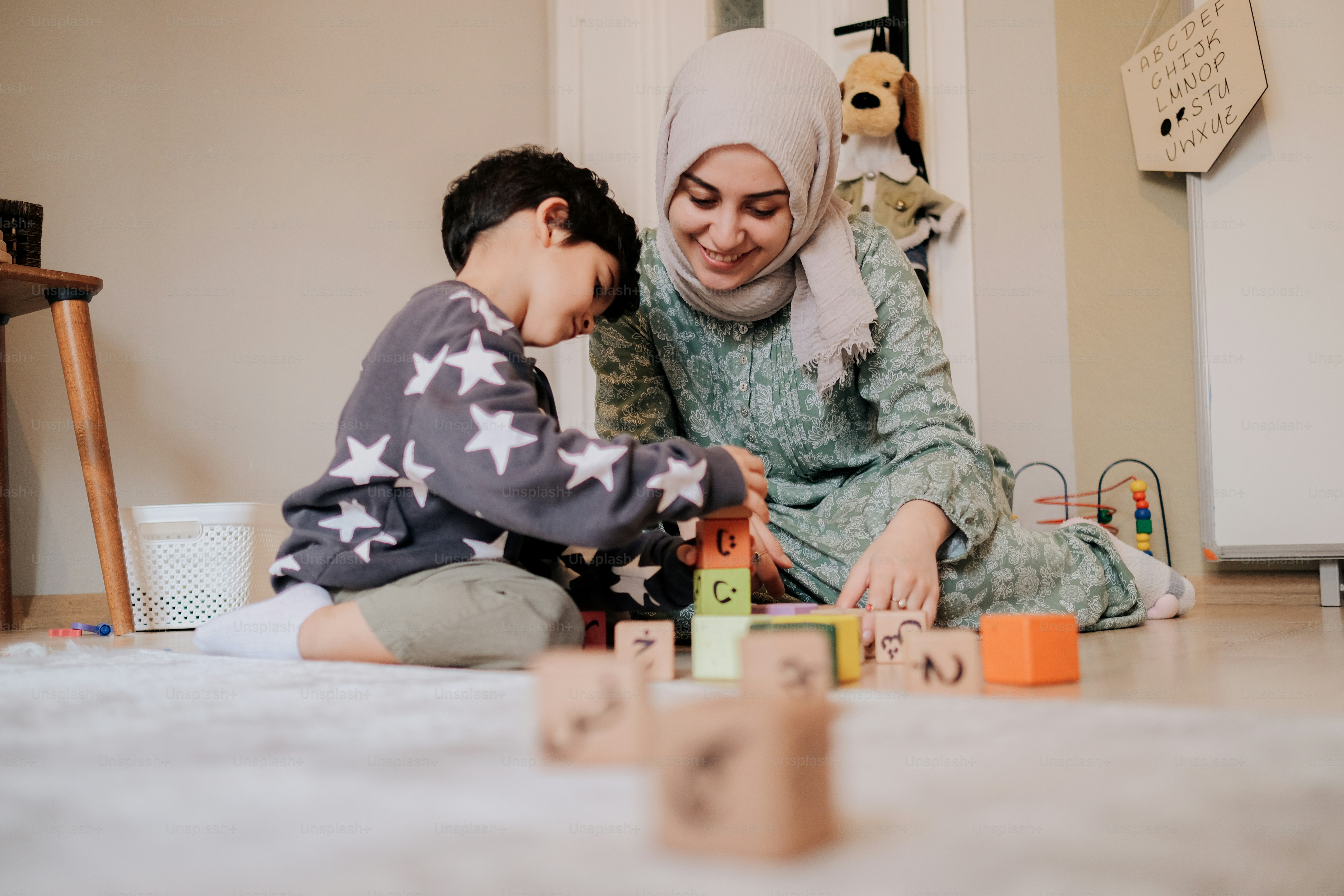 a woman playing with a child on the floor