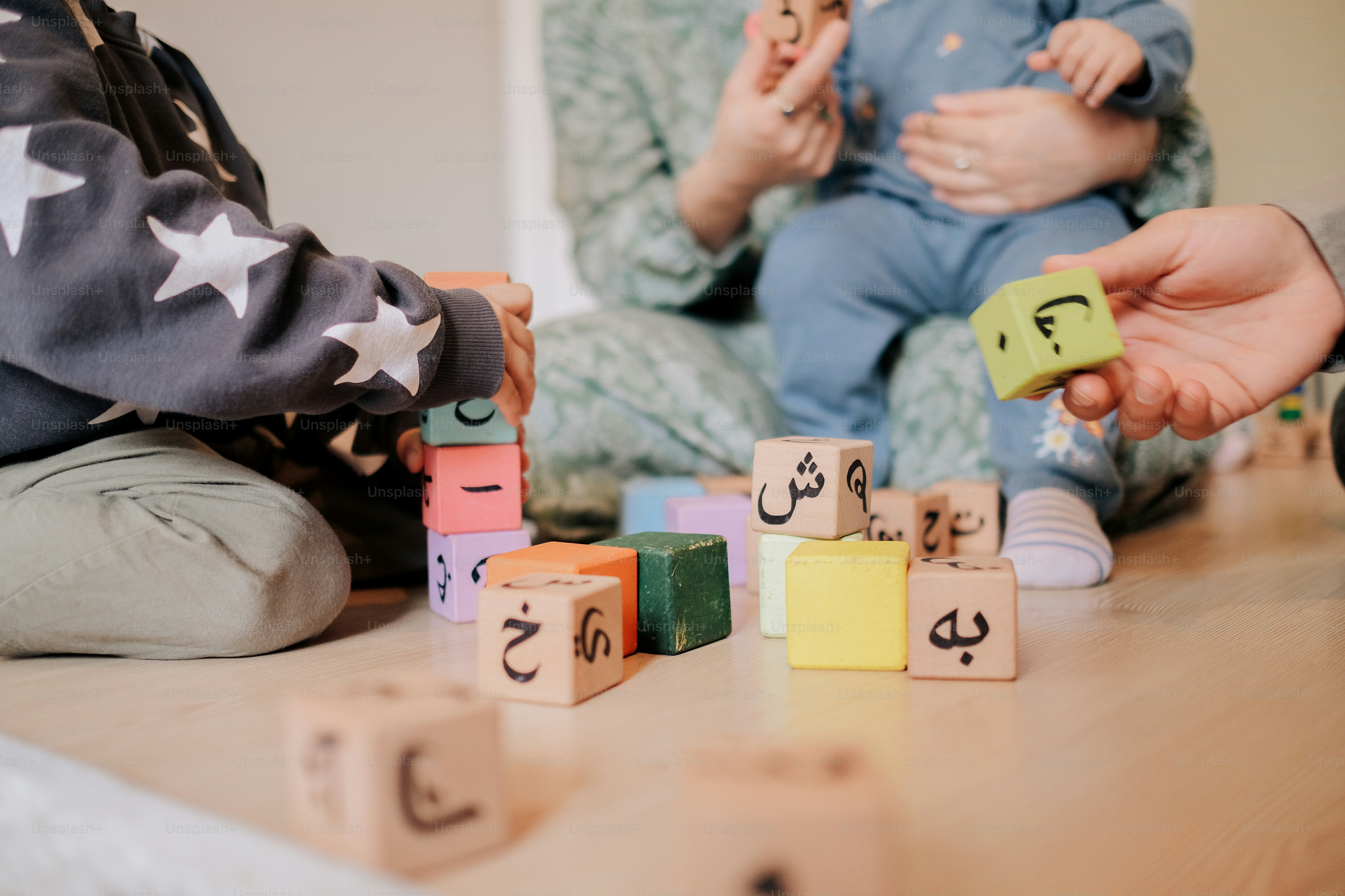 a group of people playing with wooden blocks