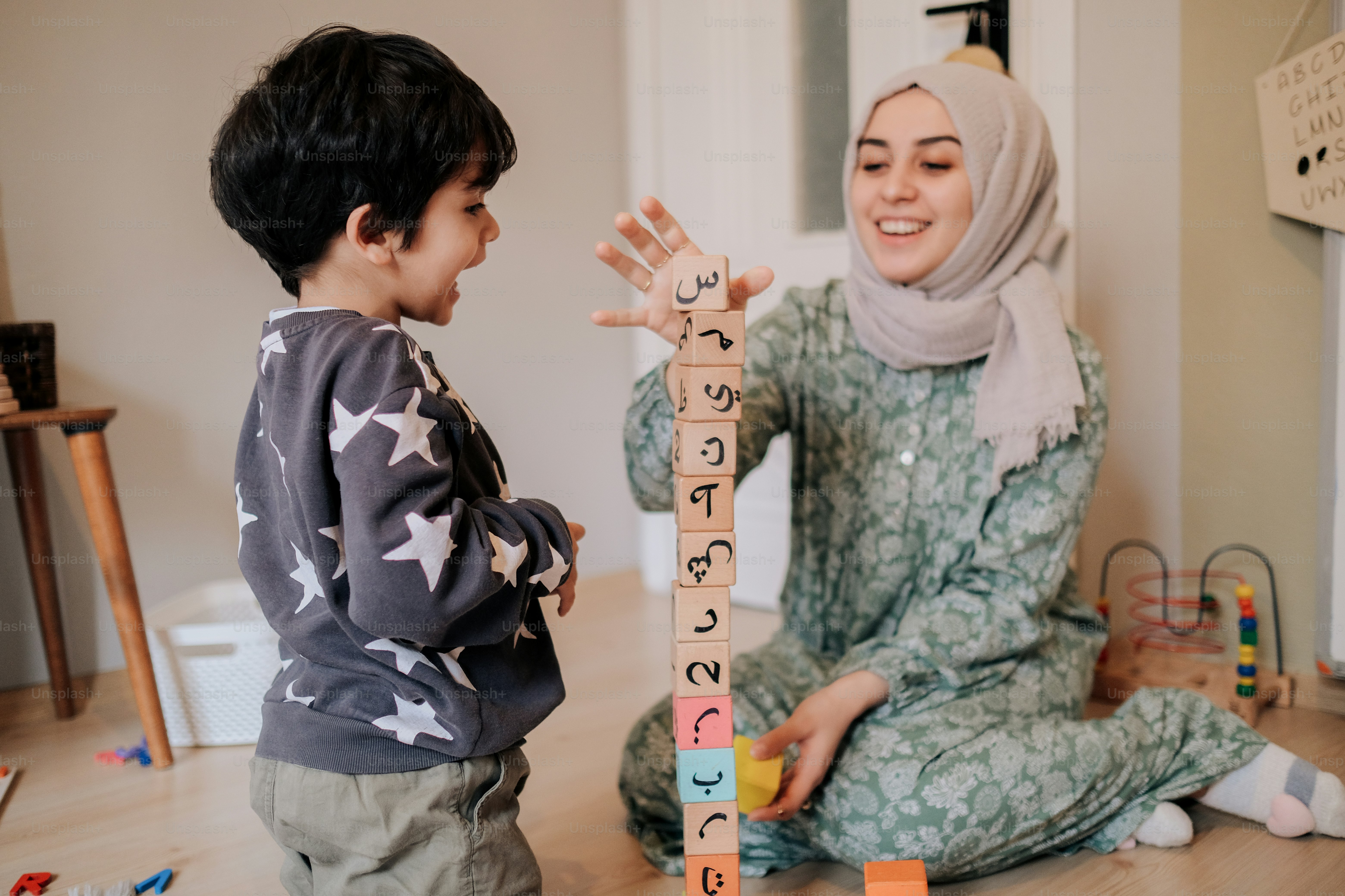 a woman and a child playing with blocks