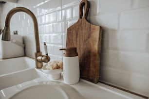 a wooden cutting board sitting on top of a kitchen counter