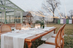 a table set for a formal dinner outside