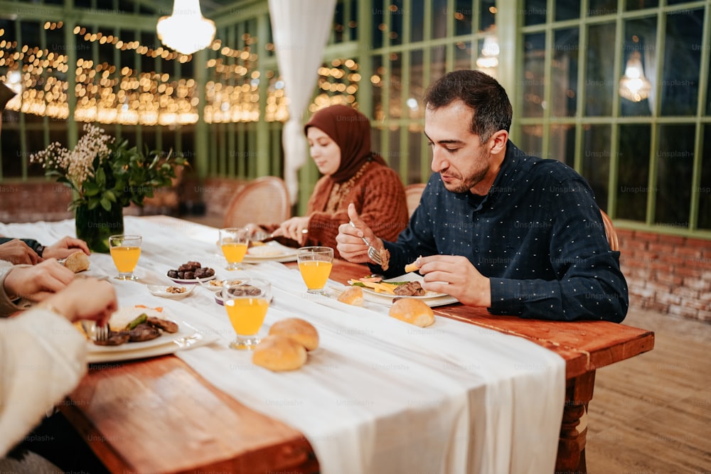 a group of people sitting around a table eating food