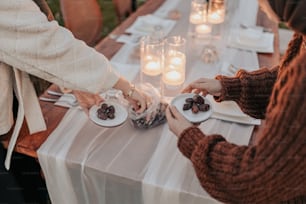 a couple of people sitting at a table with plates of food