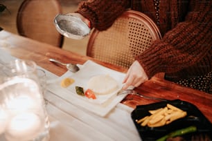 a person pouring water on a plate of food