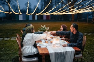 a group of people sitting around a wooden table