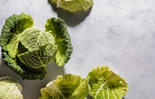 a group of green leafy vegetables sitting on top of a table