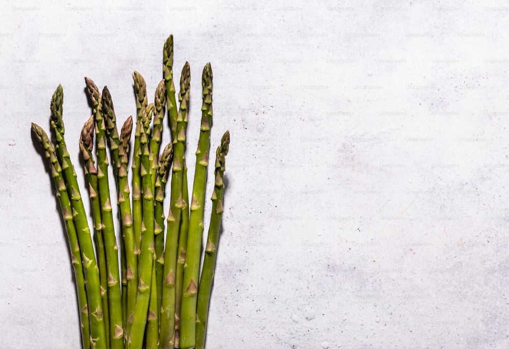 a bunch of green asparagus on a white background