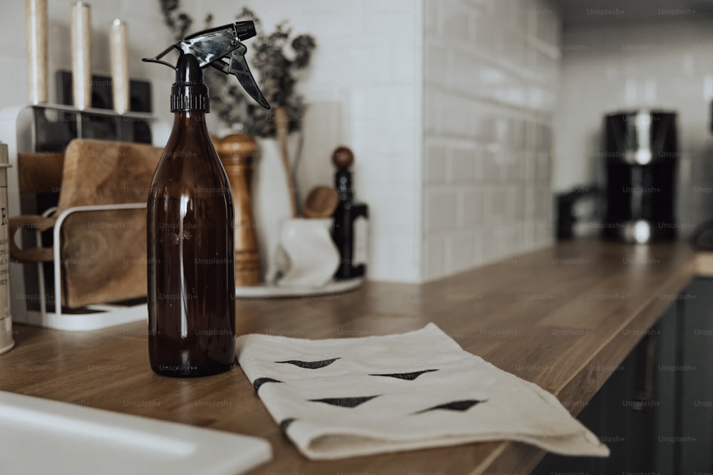 a brown spray bottle sitting on top of a wooden counter