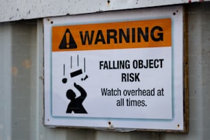a warning sign on the side of a building