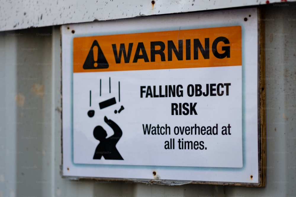 a warning sign on the side of a building