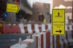 a yellow sign that is on a wooden pole