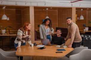 a group of people standing around a wooden table