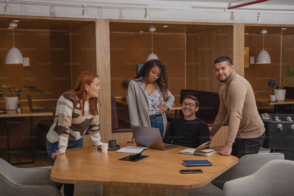 a group of people standing around a wooden table