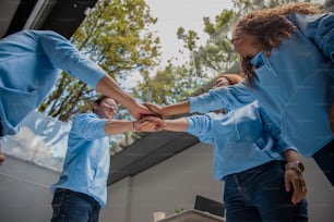 a group of people holding hands in a circle