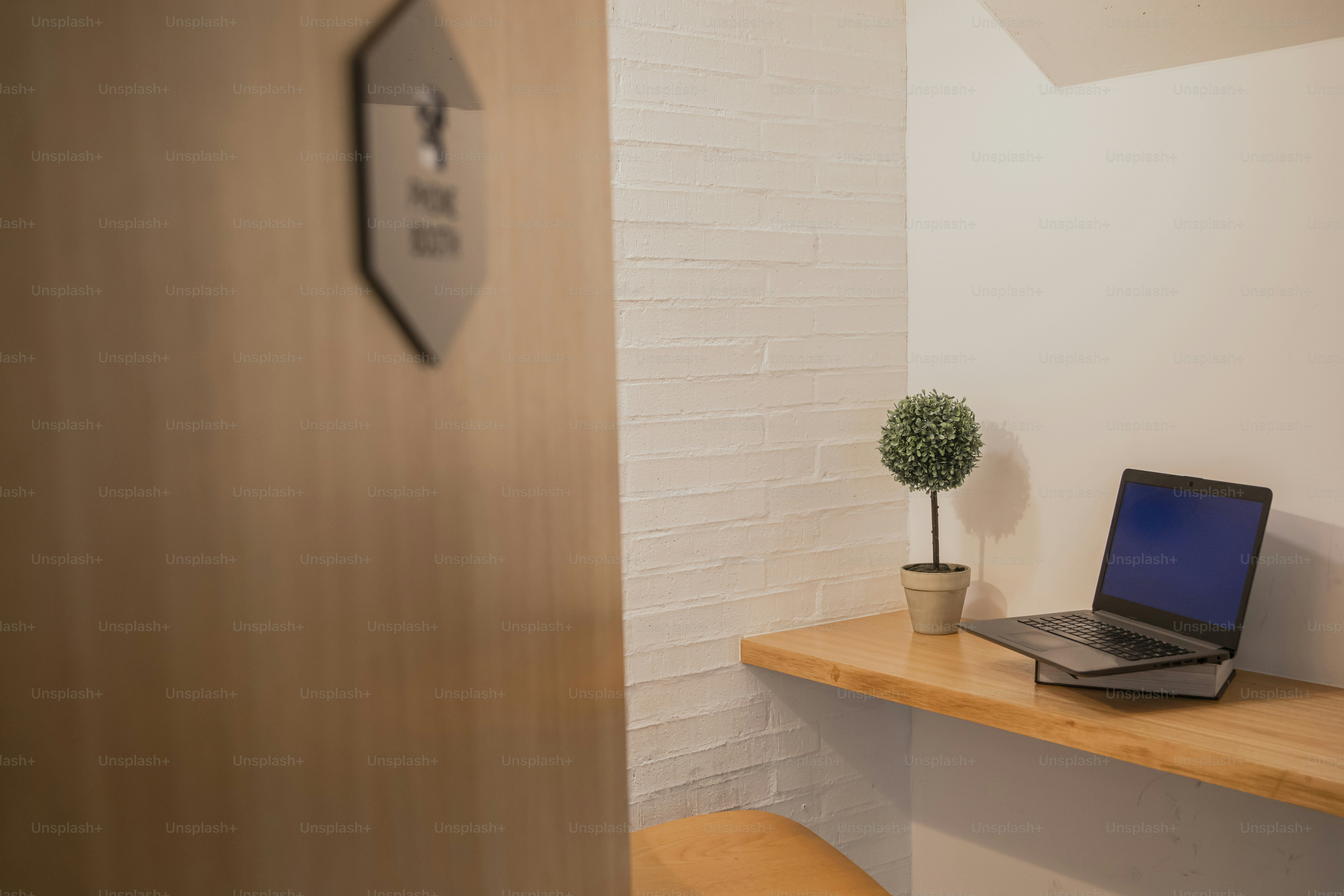 a laptop computer sitting on top of a wooden desk