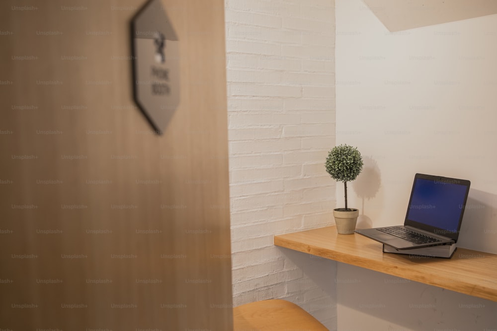 a laptop computer sitting on top of a wooden desk