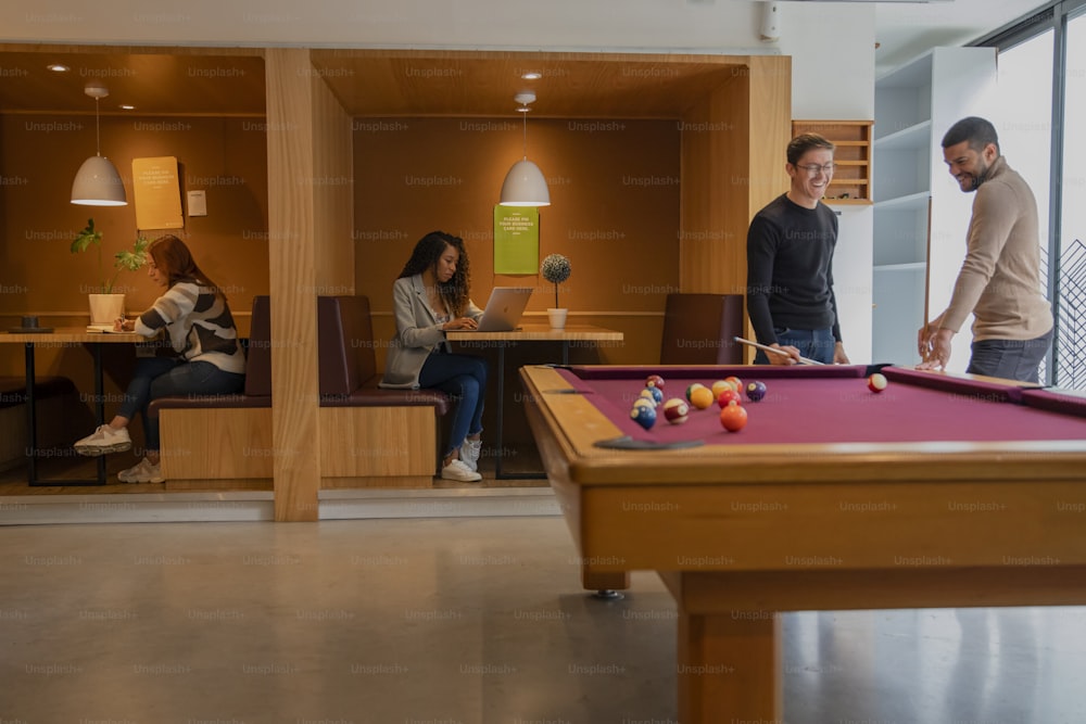 a group of people playing a game of pool