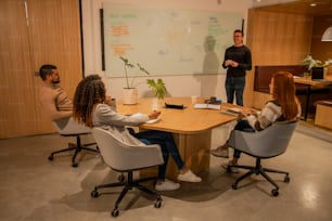 a group of people sitting around a wooden table