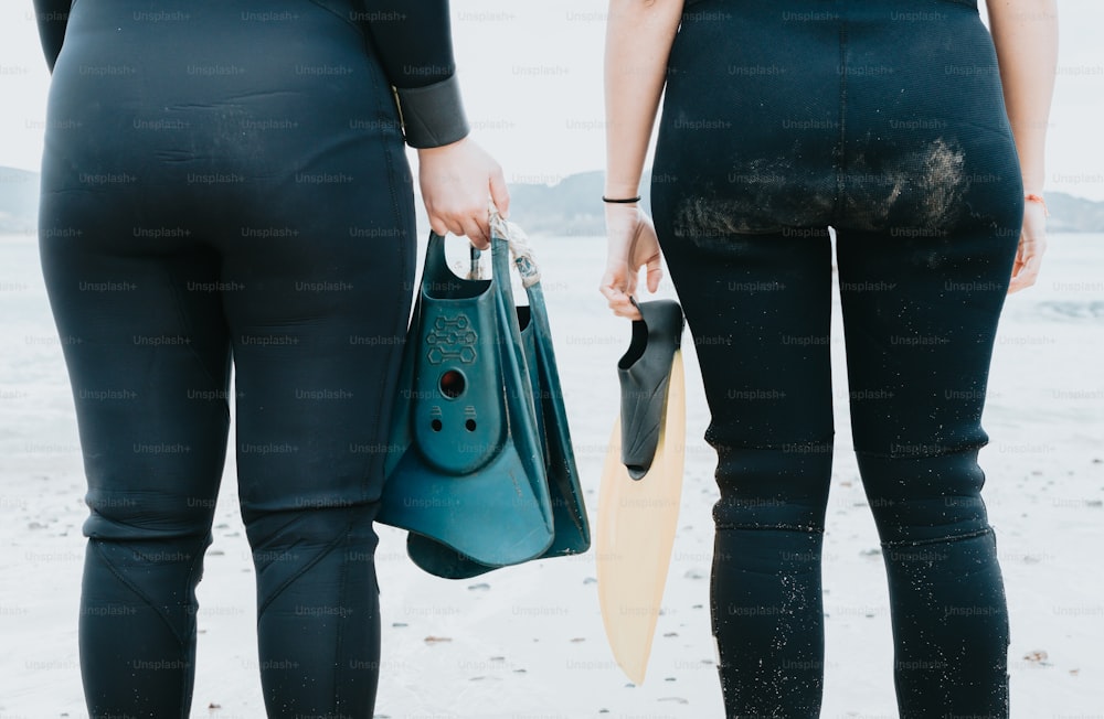 a couple of women standing next to each other on a beach