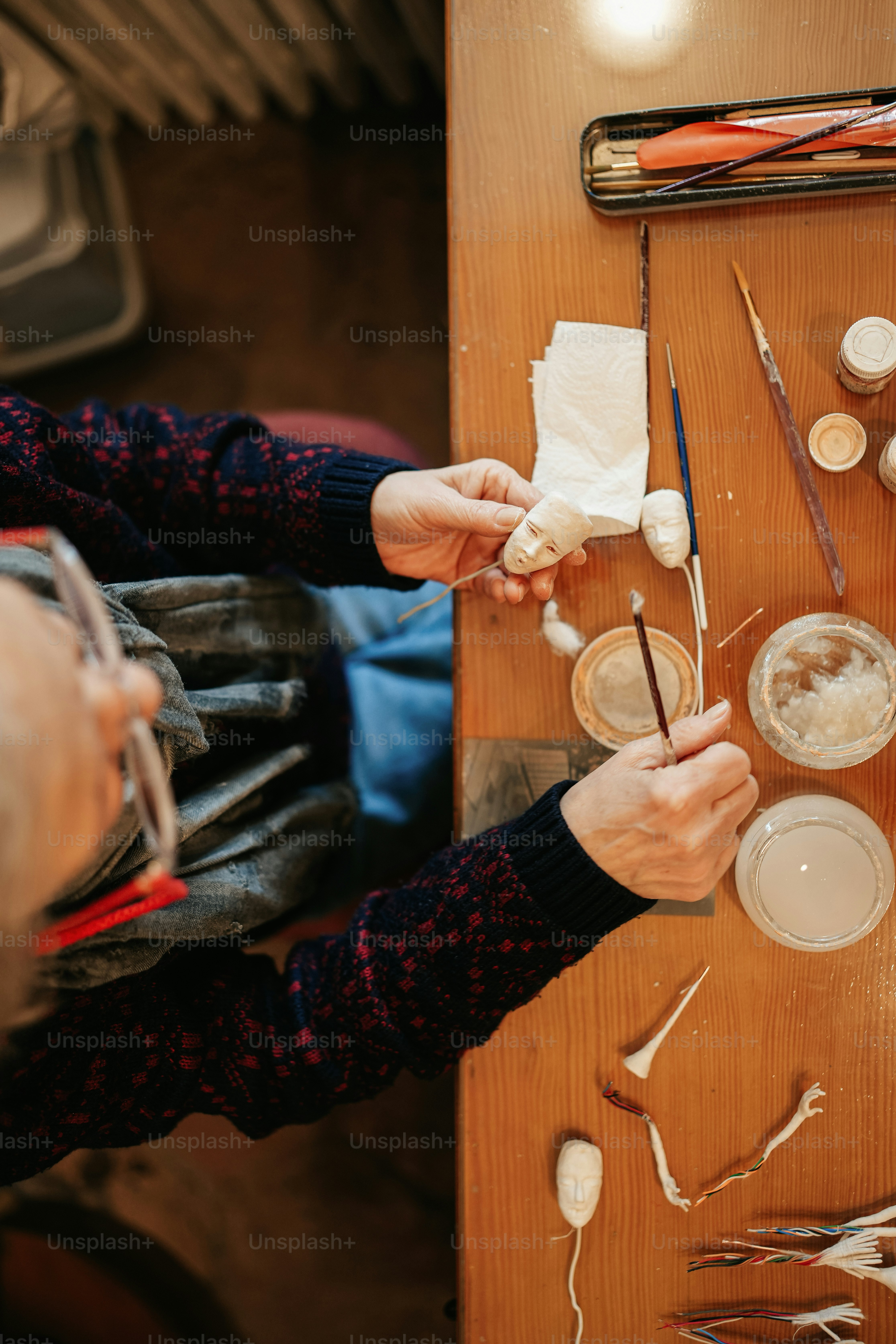 a person working on a craft project on a wooden table