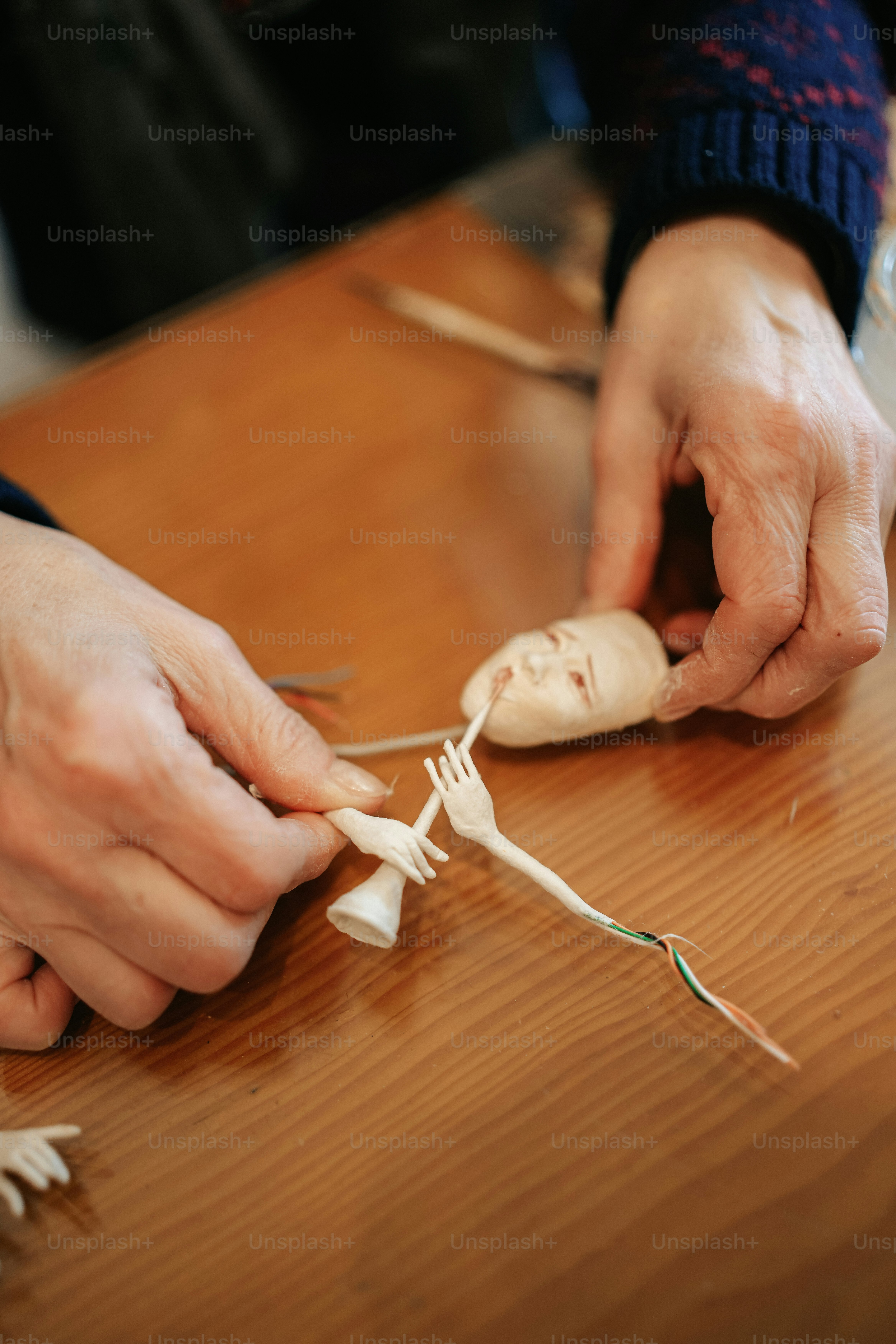 a person is holding a doll in their hands