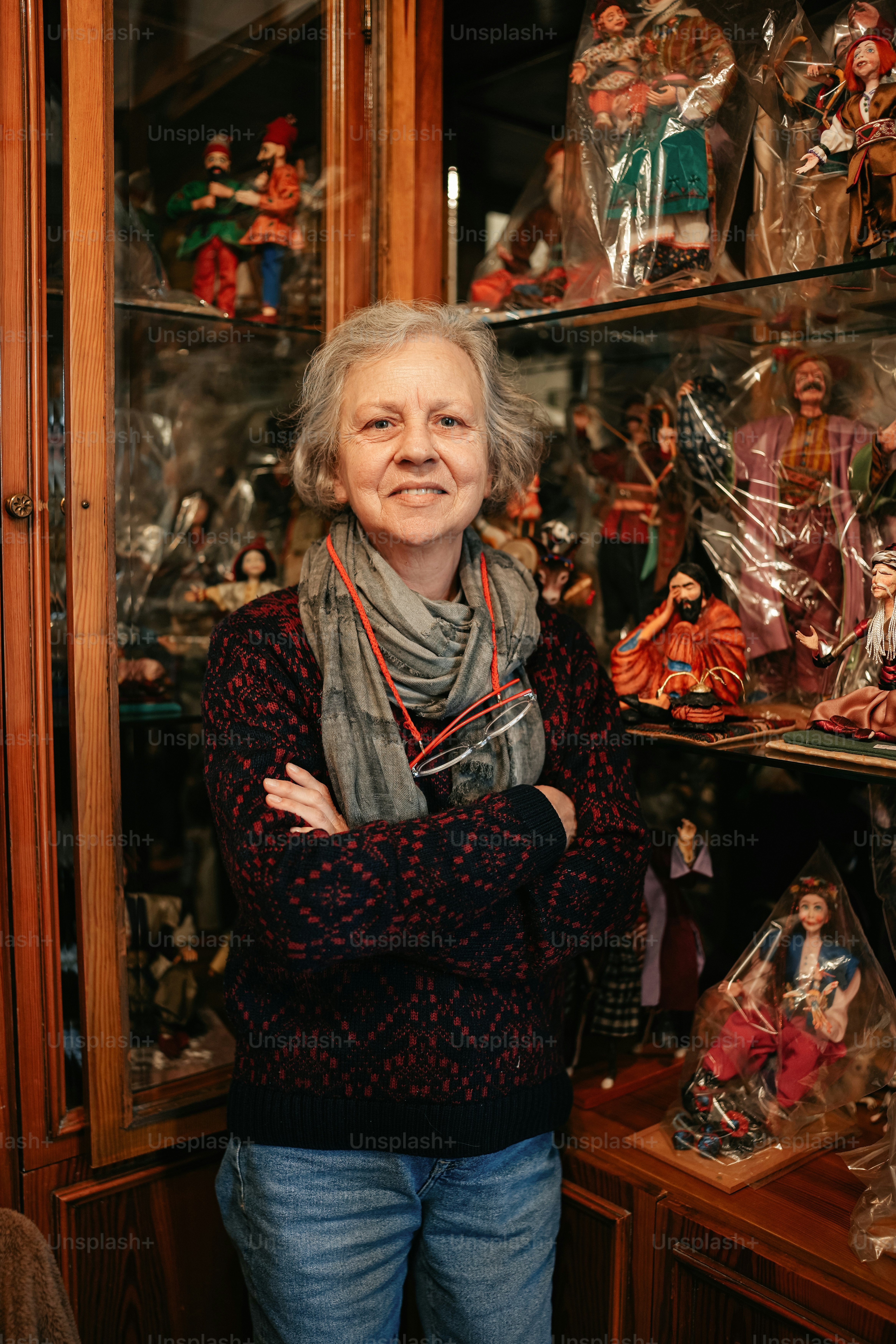 a woman standing in front of a display case filled with figurines